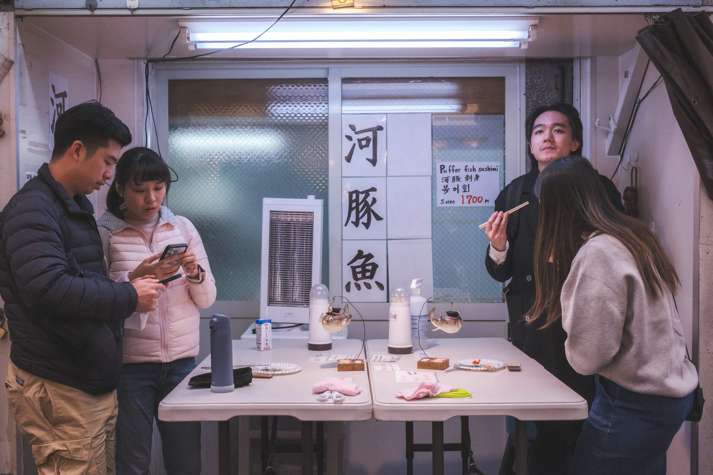 photo of people eating puffer fish sashimi 