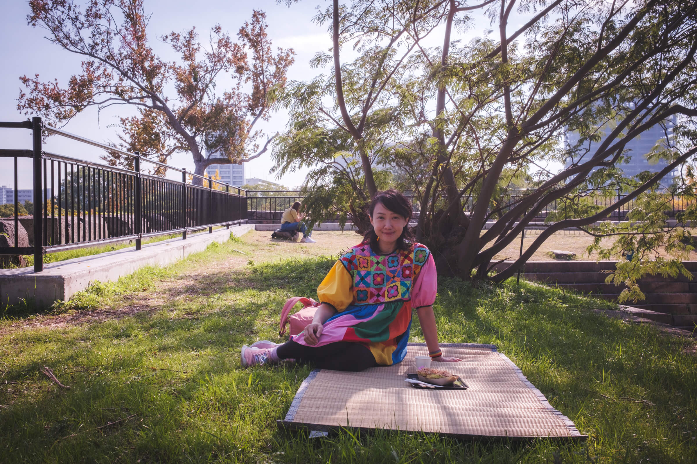 photo of my partner having okonomiyaki and takoyaki on a picnic mat