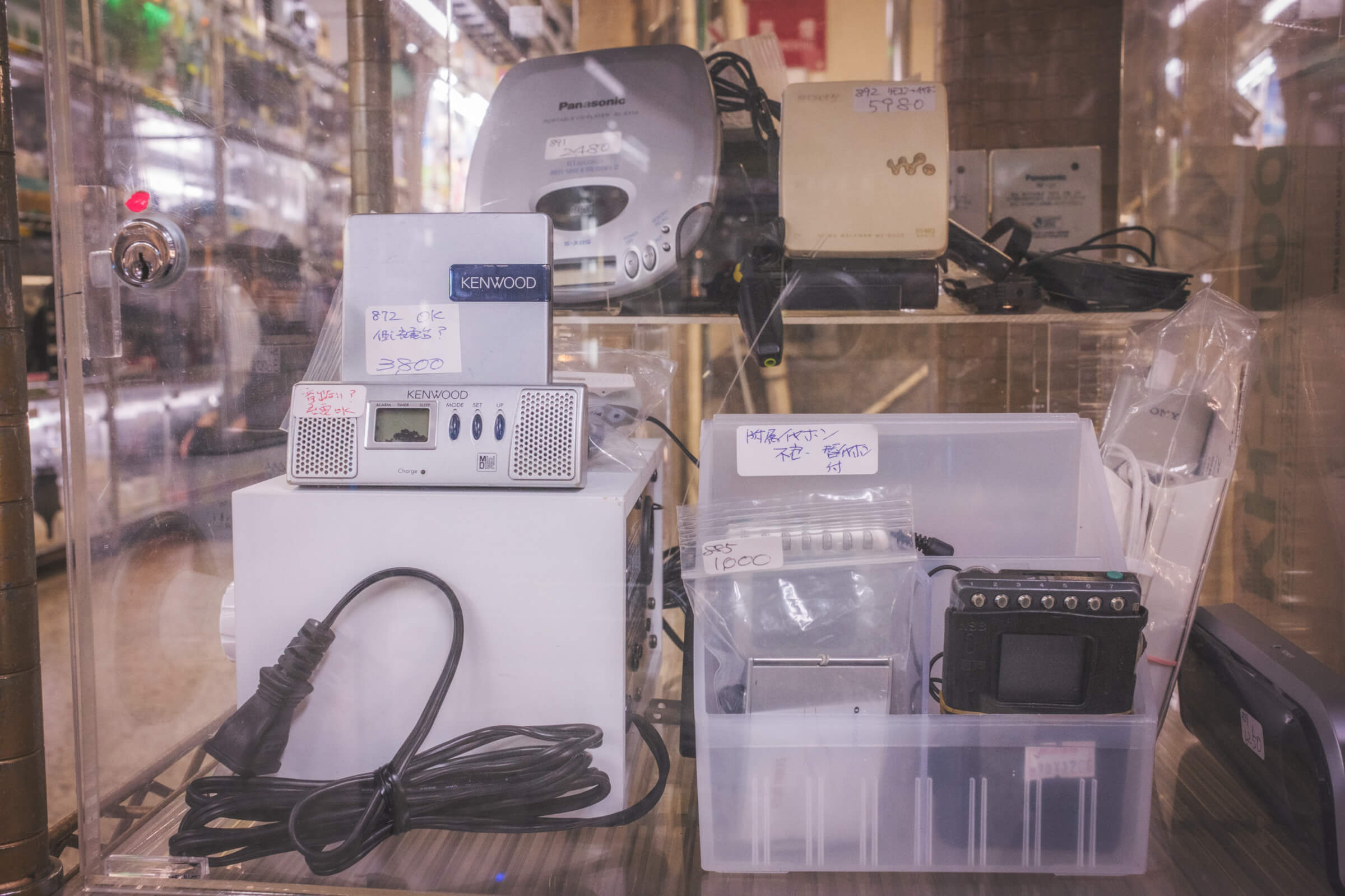 photo of a showcase at akihabara radio center displaying portable cd players and mini disc players