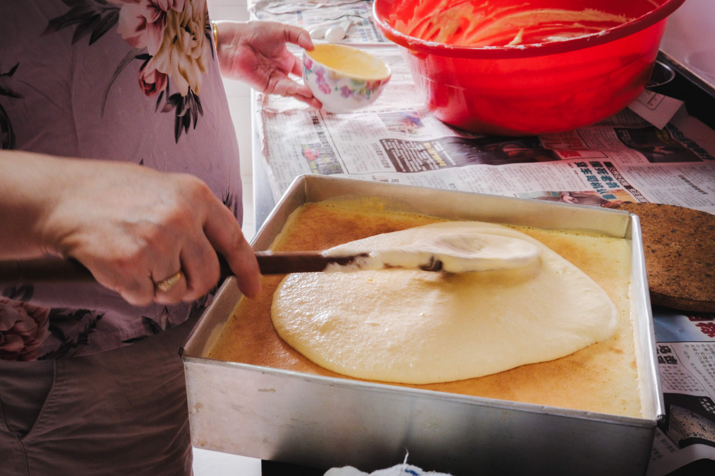photo of my mom prepping the final layer of the cake