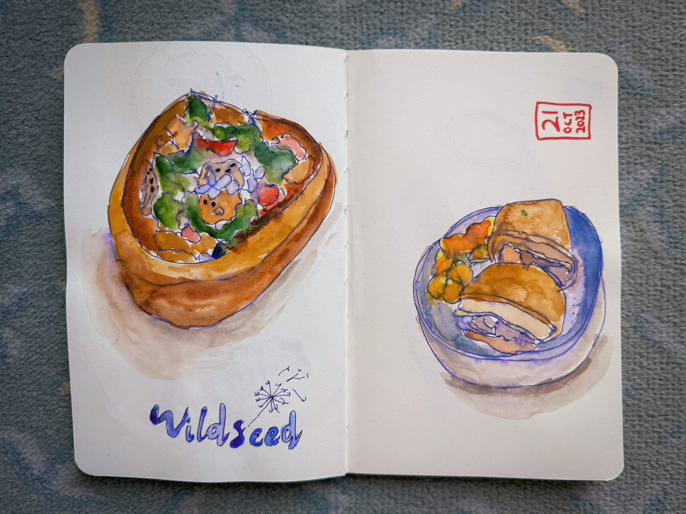 photo of my sketchbook with a painting of some food I ate at wildseed cafe