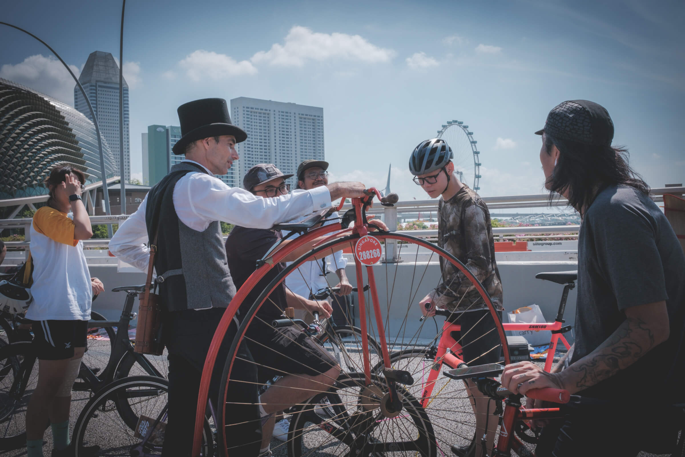 photo of a person in a suit showing their monowheel to other cyclists