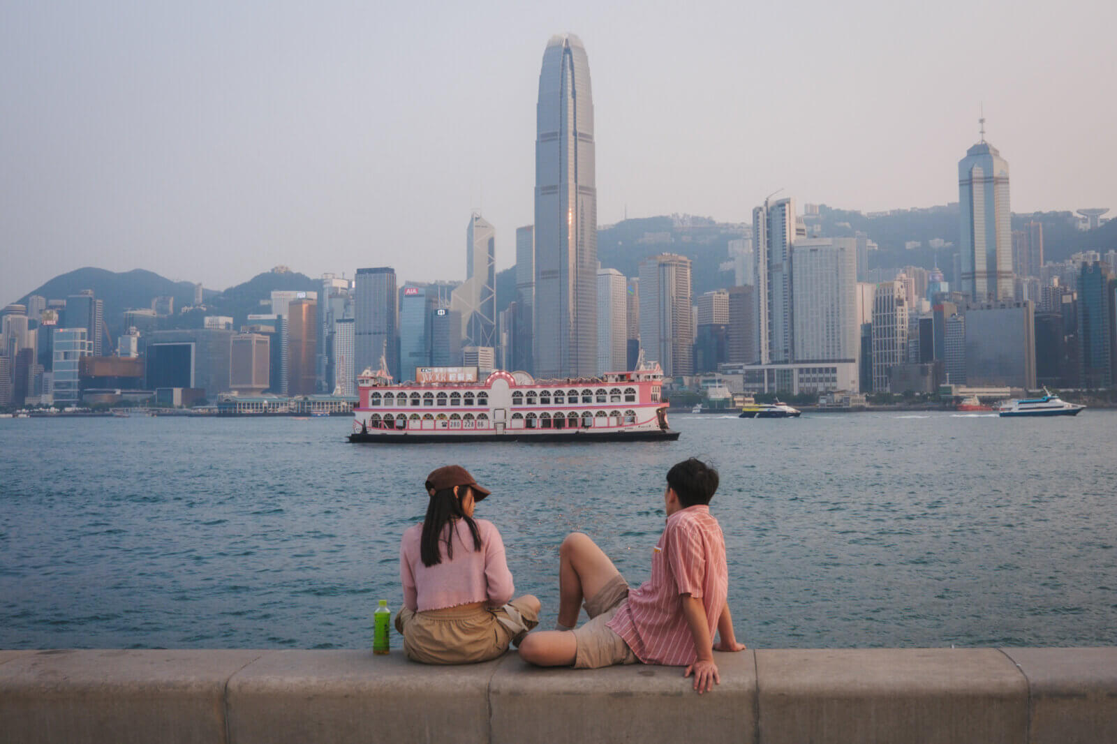 photo of couple wearing pink, with a pink ferry in the background