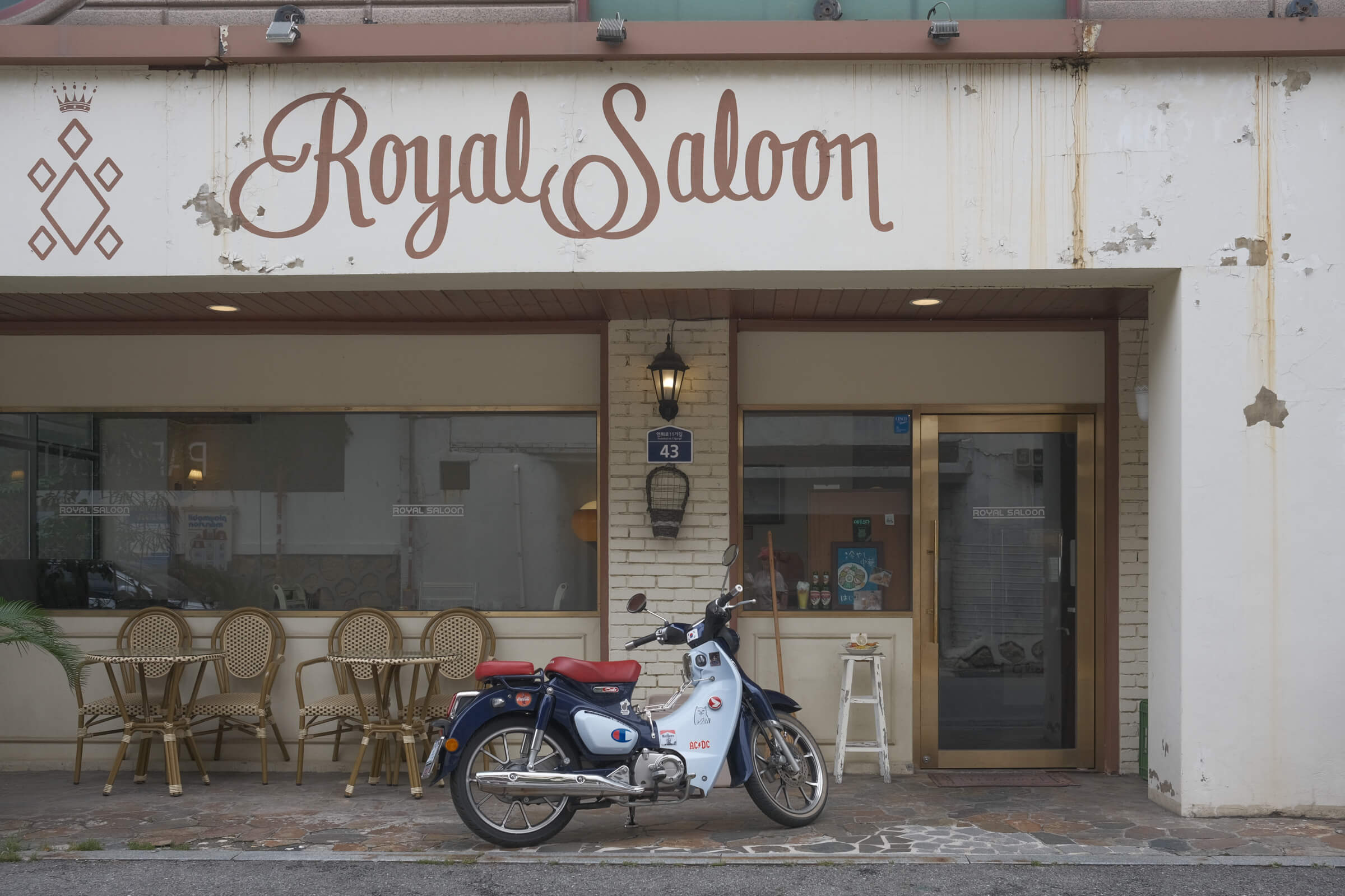 photo of a beautiful scooter in front of a matching retro-ish restaurant