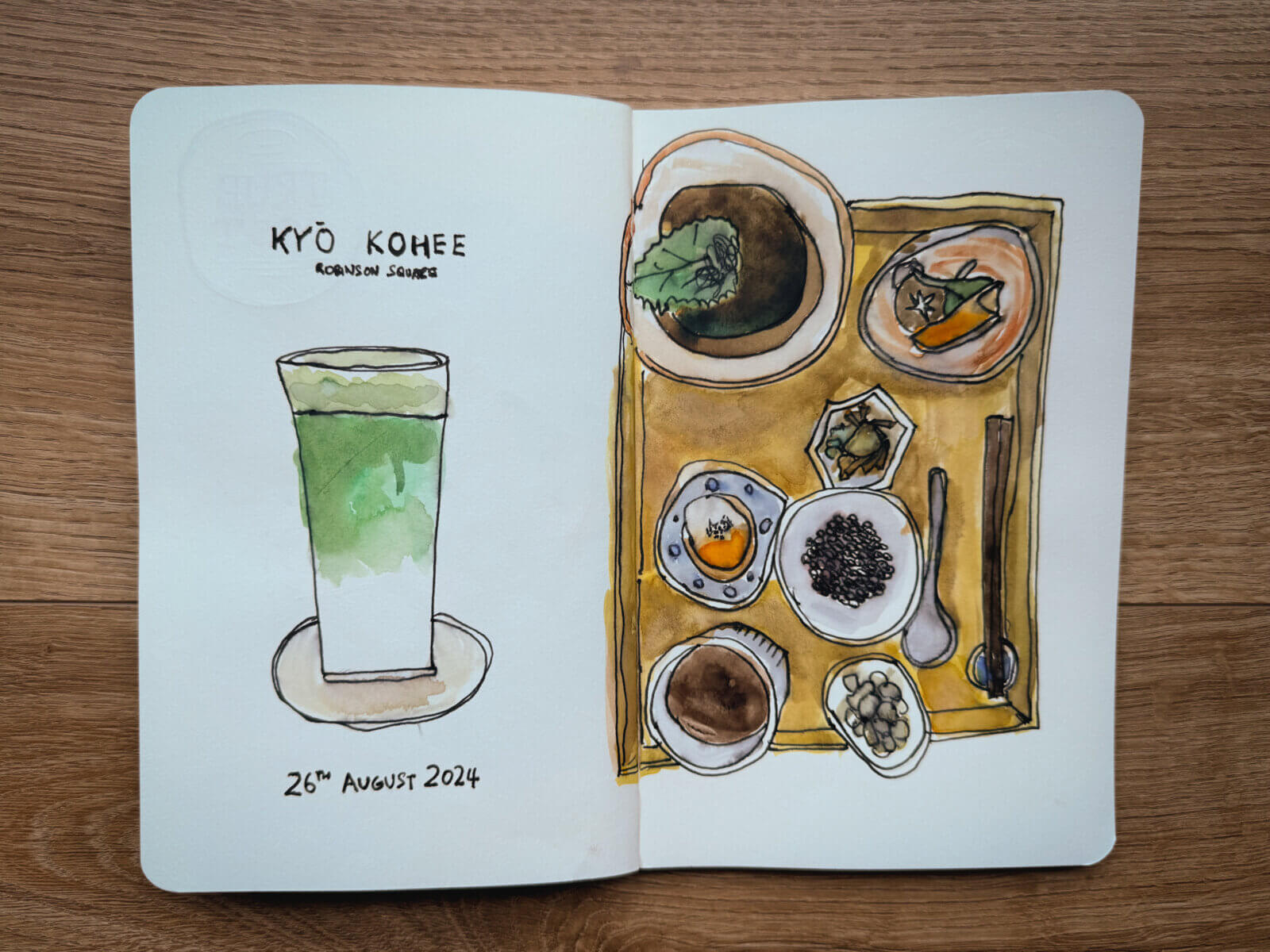 photo of sketchbook displaying sketch of kyo kohee matcha latte and bento
