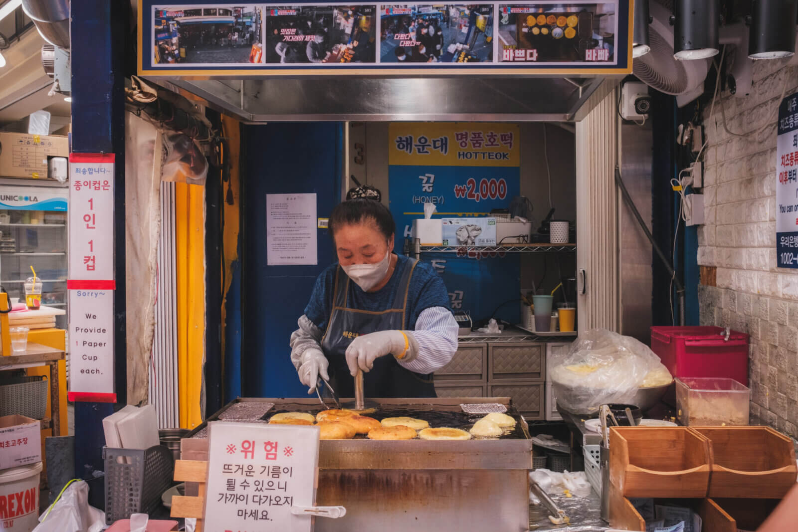 photo of a stall owner making hotteok – a type of korean dessert pancake
