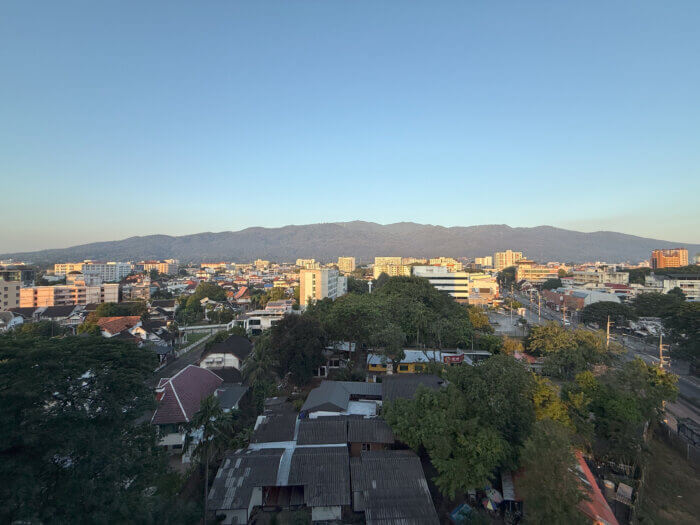 a wide shot of chiang mai with mountains in the distance