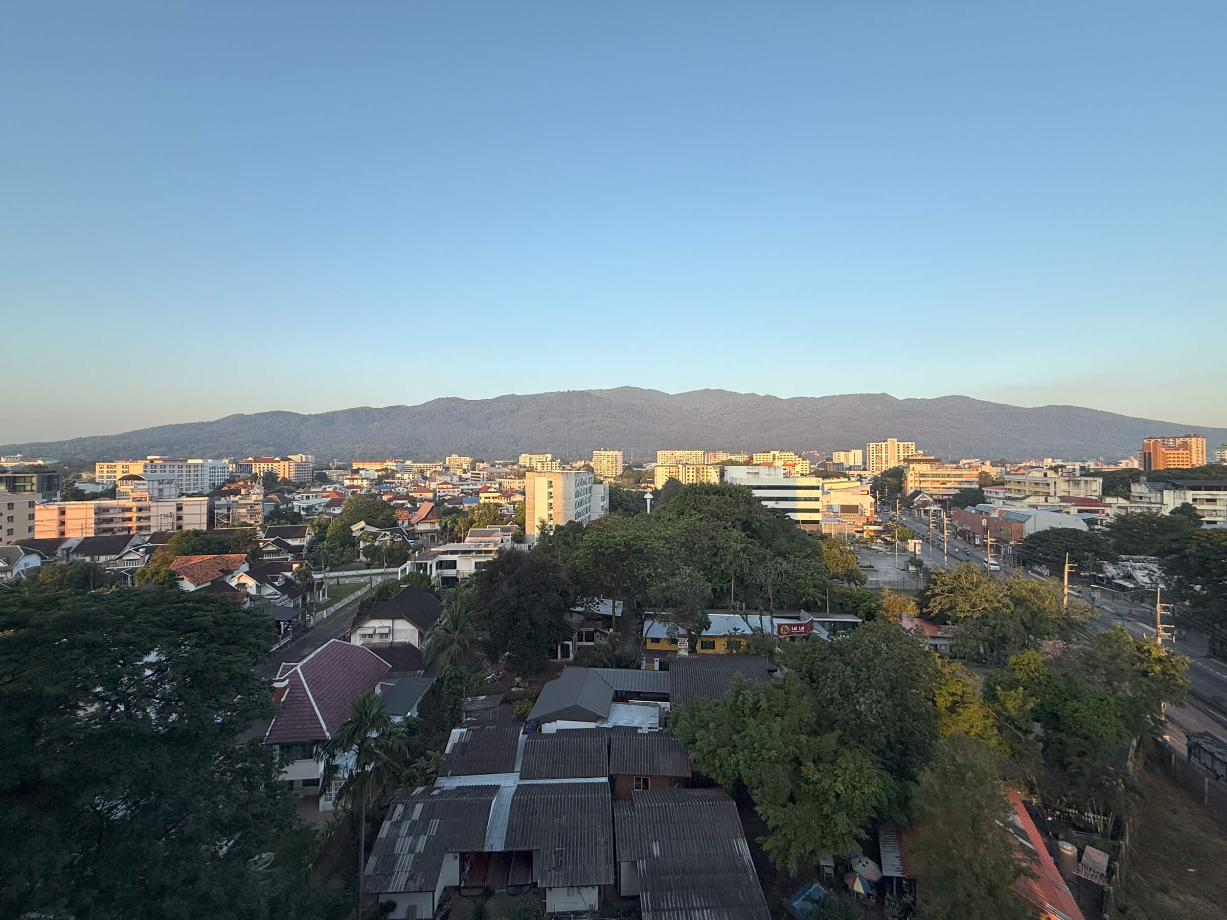 a wide shot of chiang mai with mountains in the distance