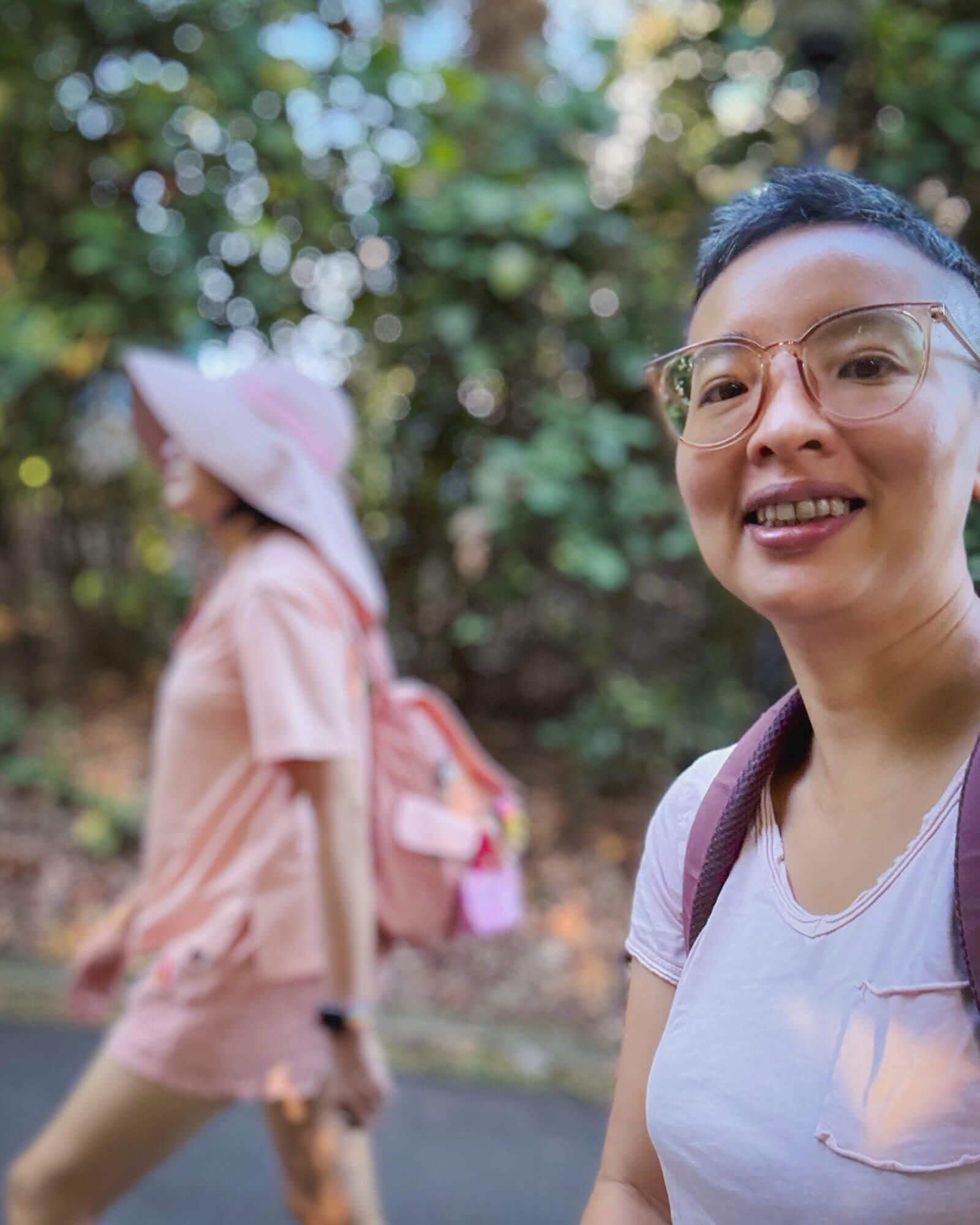 photo of me with my partner blurred in the background while we're hiking