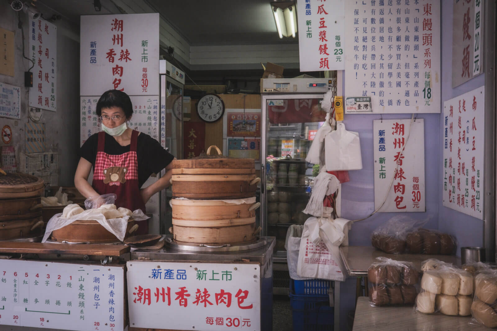 photo of a steamed bun restaurant with the vendor looking up at me