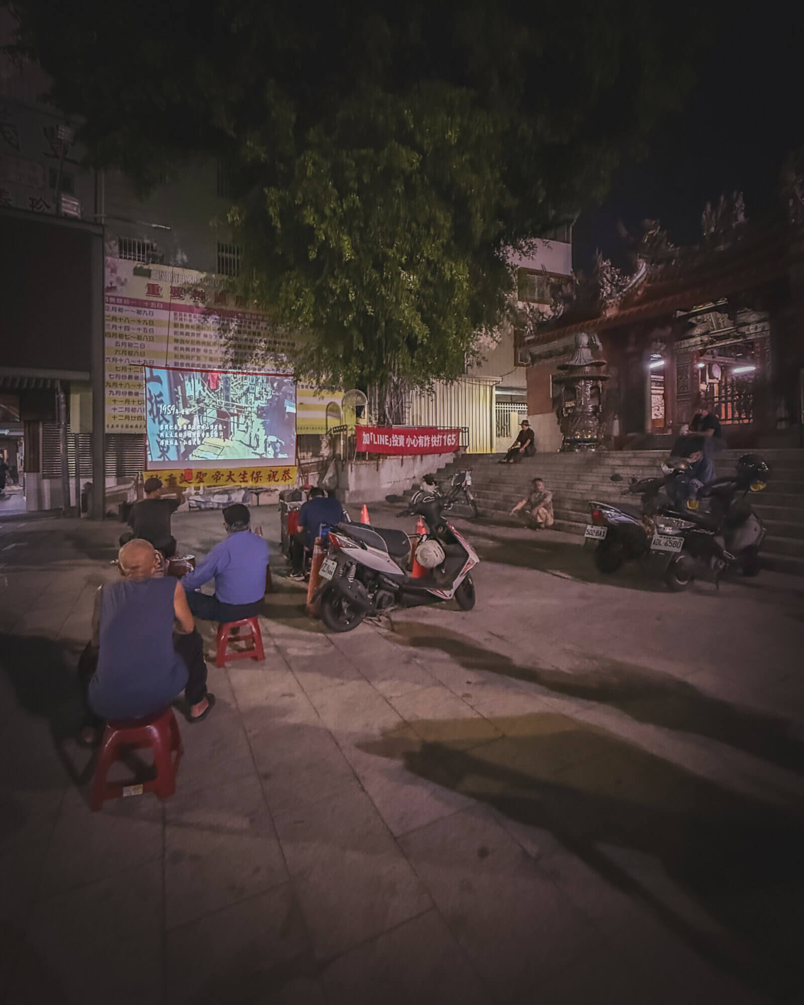 photo of people watching Ip Man 3 in open-air