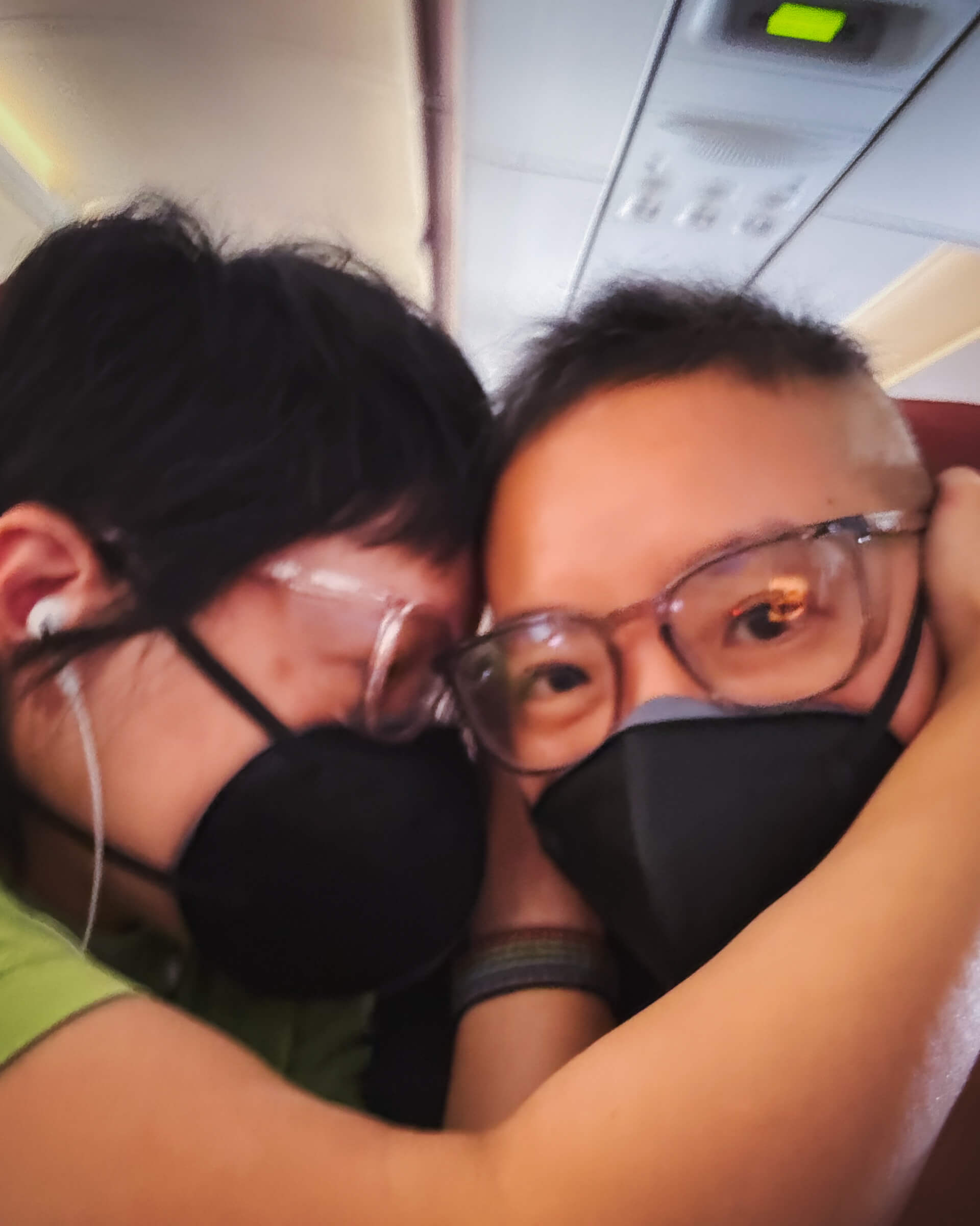 photo of my partner shielding my ears from the plane's landing noise