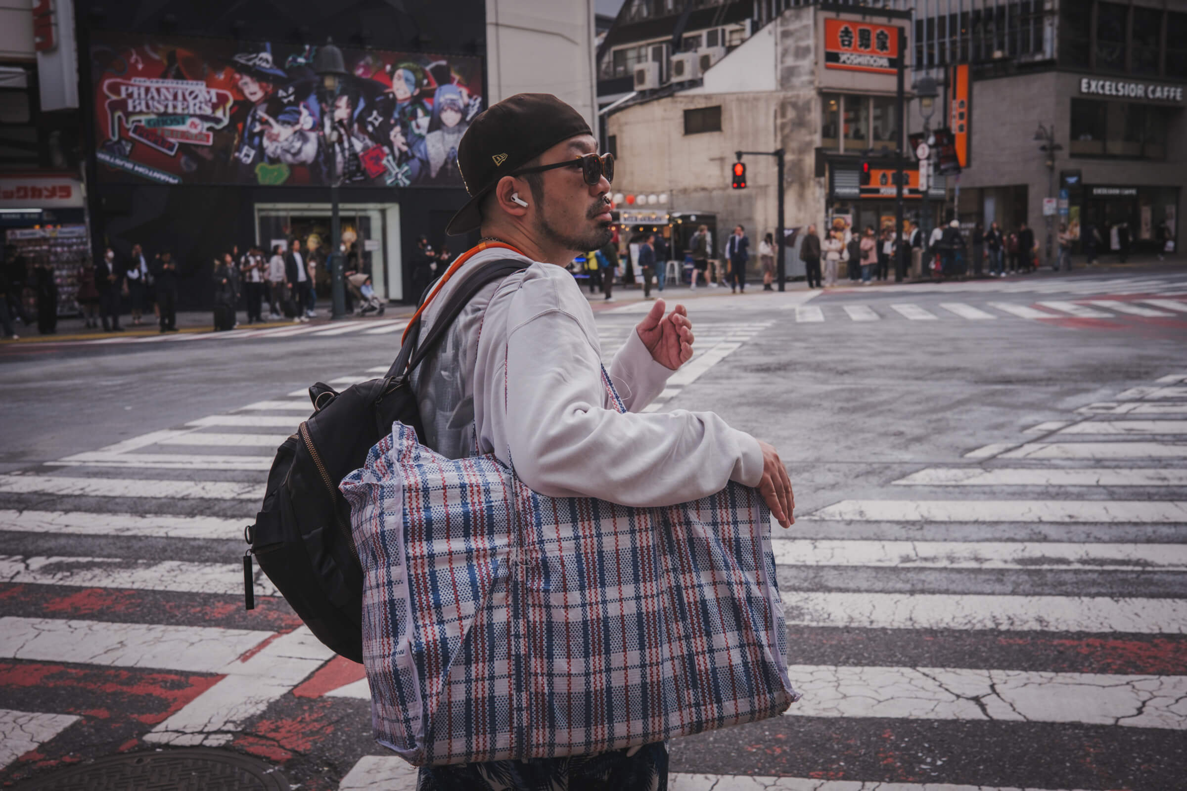 photo of a random guy waiting at a crossing