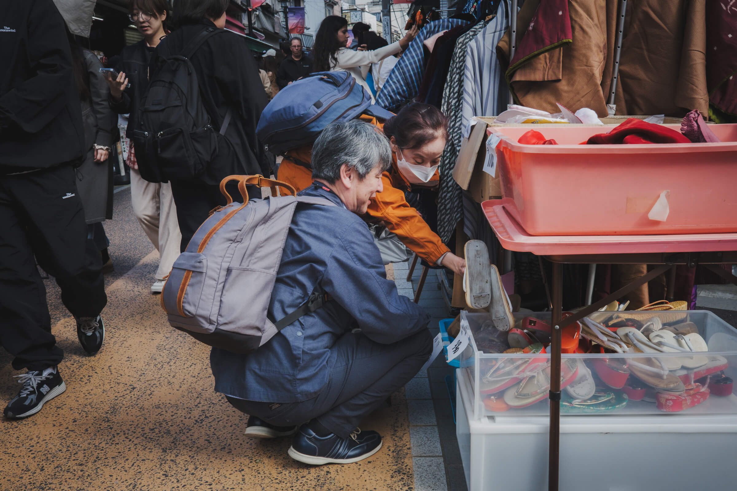 photo of people picking out stuff at a street market